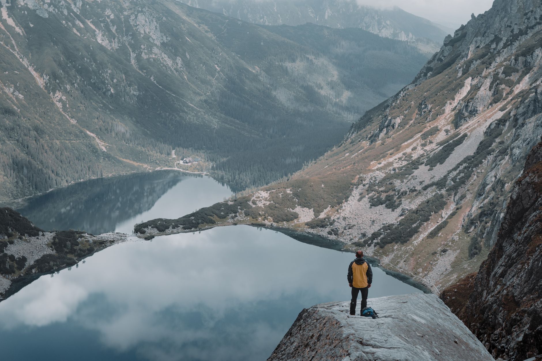 Travel writer with notebook overlooking scenic lake